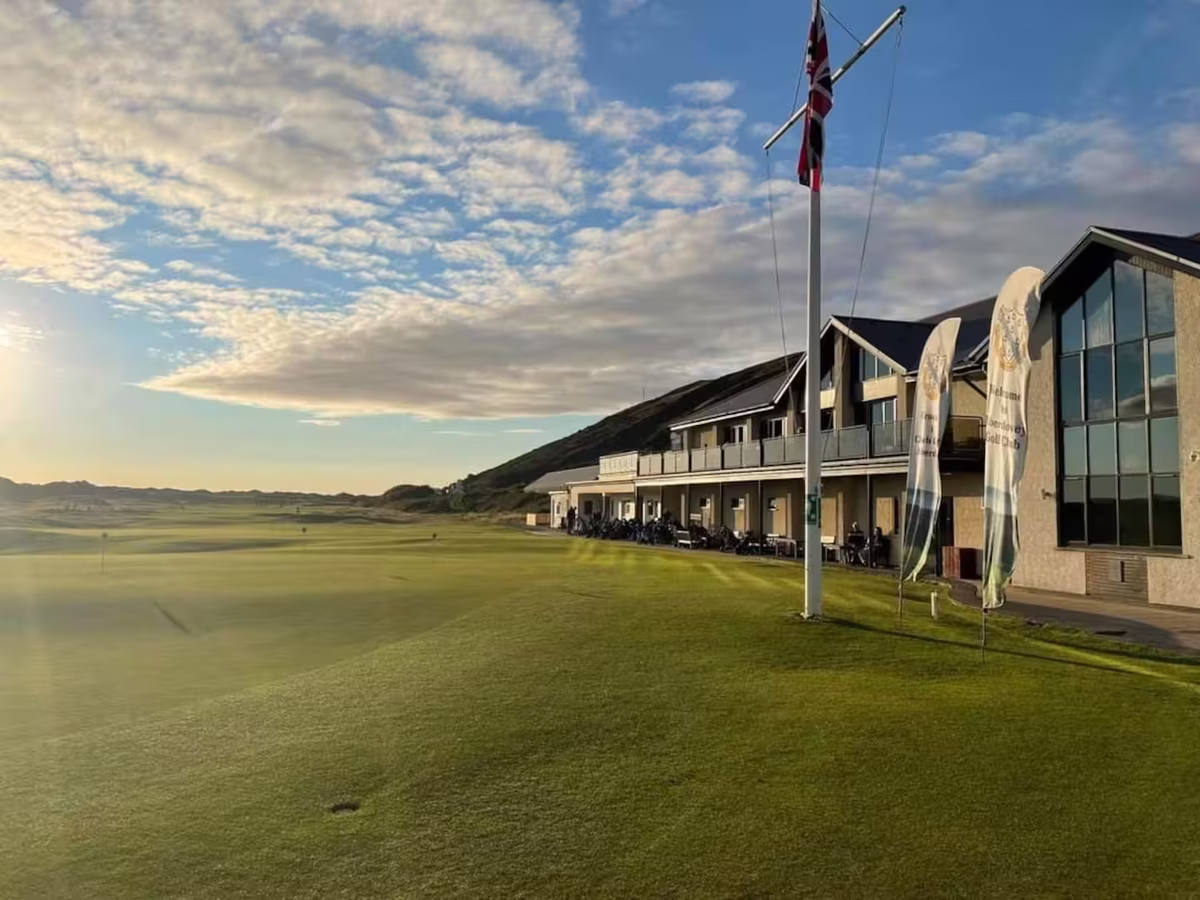 Aberdyfi Golf Club links course at sunset with mountains behind, Gwynedd, Wales