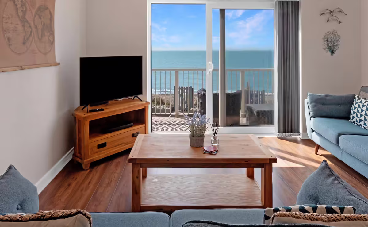 Venedotia – light-filled open-plan lounge with sliding doors to balcony