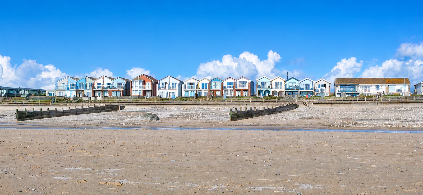 Tywyn seafront from the beach — the row of beachfront homes including Four Degrees West and Venedotia, Cardigan Bay, Mid-Wales